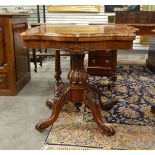 Victorian rosewood card table with hinged top, on quadruped carved cabriole legs and castors,