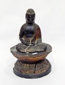 Late 18th/early 19th century lacquered carved wooden model of a seated Buddha with gilt highlights,