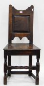 Late 18th/early 19th century oak standard chair with shaped crest rail and field panelled back,