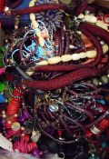 Large quantity of costume jewellery including a stained wooden bead necklace, an enamel pendant,