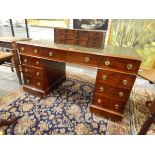 Mahogany kneehole pedestal desk having tooled leather inset top,