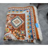 Large wool rug, the orange ground with blue,