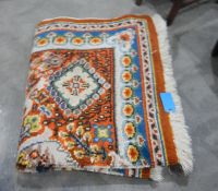 Large wool rug, the orange ground with blue,