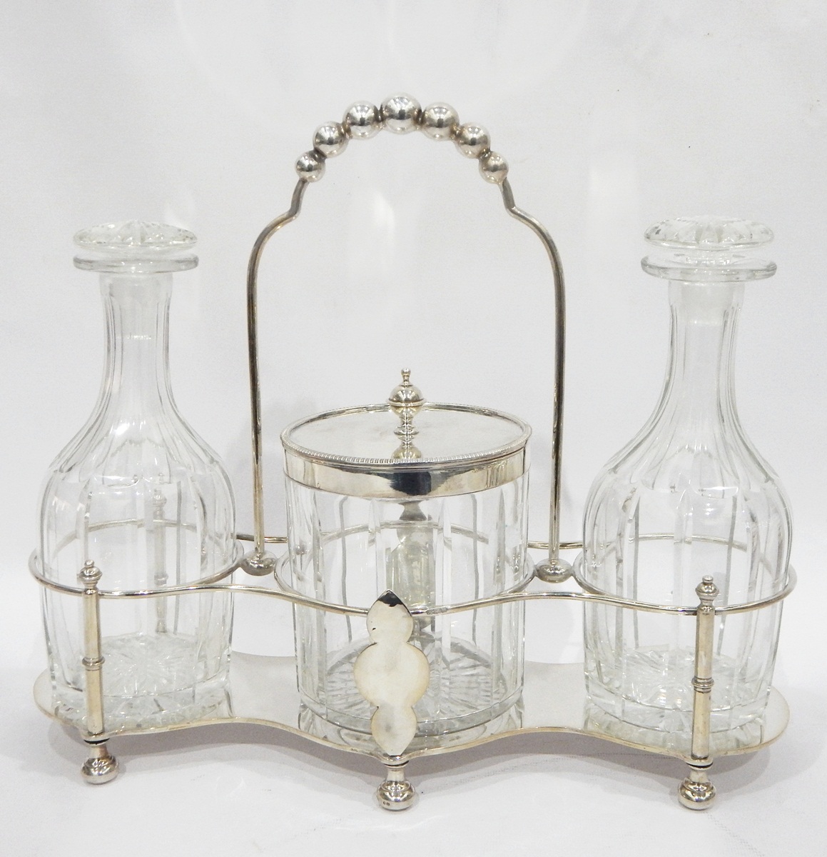 Victorian silver tantalus with two cut glass decanters and a silver-mounted ice bucket,