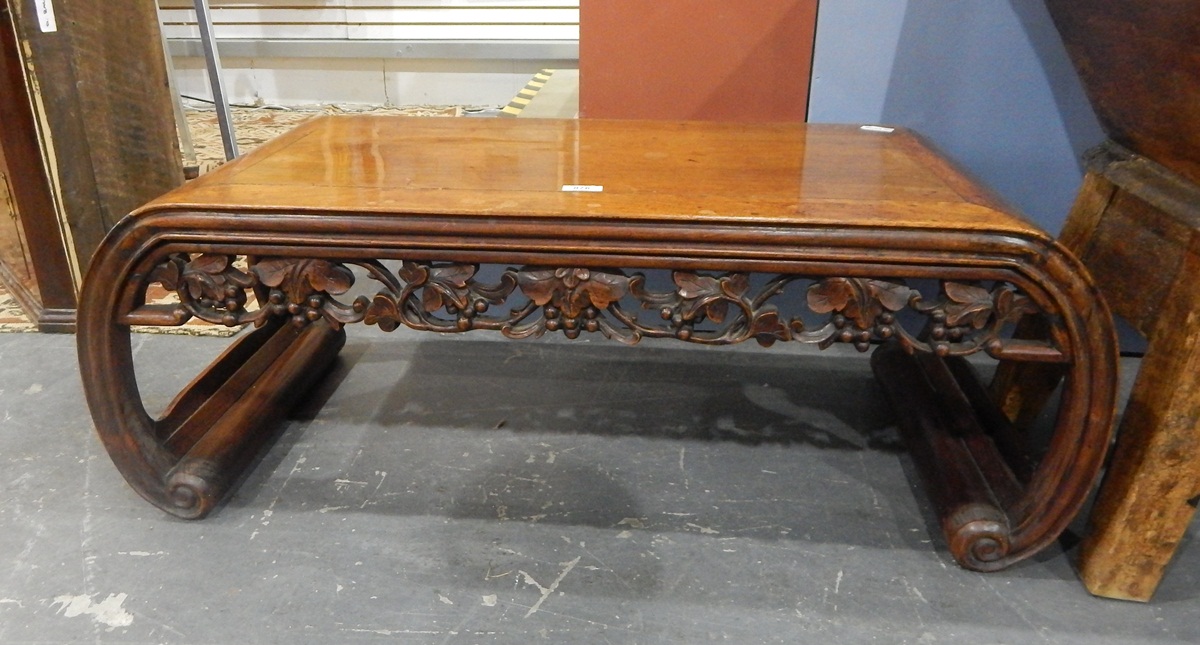 Oriental-style table with fret carved apron and on curved supports