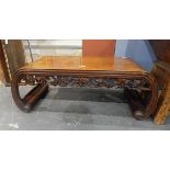 Oriental-style table with fret carved apron and on curved supports