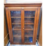 Victorian mahogany bookcase enclosed by two glass panelled doors,