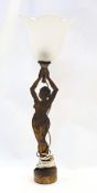 1920s Brass metal table lamp modelled as a nude female supporting a glass flower shaped shade, 40.