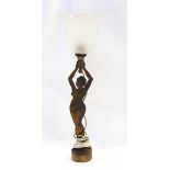 1920s Brass metal table lamp modelled as a nude female supporting a glass flower shaped shade, 40.