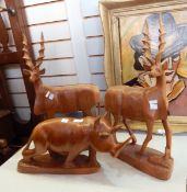 Carved wooden rhinoceros (damaged) and a pair of carved wooden kudu,