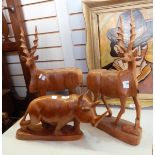 Carved wooden rhinoceros (damaged) and a pair of carved wooden kudu,