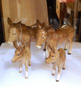 Two Beswick model donkeys and two smaller Beswick model donkeys (4)