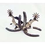 Pair of bookends made from two cast horseshoes and cast cowboy spurs with rowel,