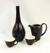 Poole - black ovoid vase with narrow neck, two coffee pots,