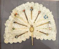 19th century bobbins framed around lace to form the shape of a fan,