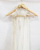 Three modern white net wedding veils, one with a head-dress and four vintage veils,