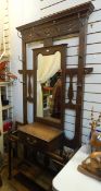 An arts and crafts style Edwardian oak hall stand, with mirror, drip trays,