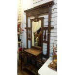 An arts and crafts style Edwardian oak hall stand, with mirror, drip trays,