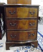 Mahogany serpentine front small chest of three long drawers, raised on bracket feet,