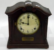 American stained mahogany mantel clock in arched top case with brass plaque for presentation