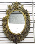 Oval wall mirror within a foliate fret frame,