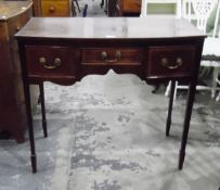Edwardian mahogany bowfront side table with one shallow and two deep frieze drawers above a shaped