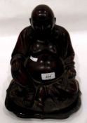 Early 20th century large carved hardwood figure of a seated laughing Buddha with bone teeth,