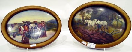 Pair of ceramic painted wall plaques, ploughing scene and cattle by lake, oval, signed 'G.