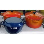 Two large orange Le Creuset casserole dishes and a blue enamel casserole dish marked 'Denmark'