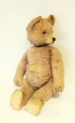 Old plush teddy bear with key winder to turn head,