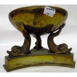 Brass circular bowl on three dolphin-shaped supports and stand,