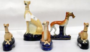 Pair of Staffordshire model greyhounds lying down, 12cm high,