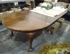 Georgian-style mahogany wind-out dining table with rounded ends and moulded edged top,