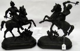 Pair of spelter knights on horseback, on oval wooden plinth bases, 41cm high approx.