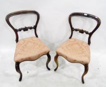 Pair of Victorian rosewood-framed dining chairs having carved horizontal splat,