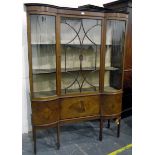 Early 20th century double-bowfront china display cabinet having astragal-glazed central door over a