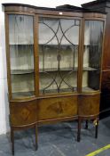 Early 20th century double-bowfront china display cabinet having astragal-glazed central door over a