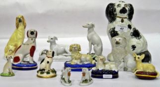 Various Staffordshire pottery model dogs to include a black and white spaniel, 19cm high, an Afghan,