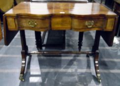 Georgian-style mahogany drop-flap side table with serpentine front, a pair of frieze drawers,