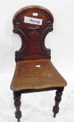 Victorian mahogany hall chair, the shaped and carved back with cartouche and with solid seat,