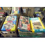 Three boxes of assorted jigsaw puzzles including Waddingtons circular jigsaws,