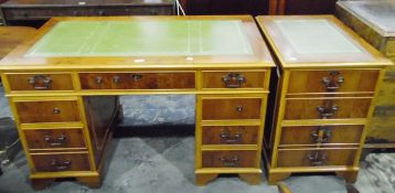 Modern yew wood veneer pedestal desk with inset writing surface, three frieze drawers,