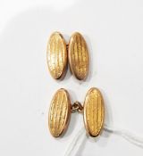Pair of 9ct gold cufflinks, oval with striped decoration,