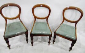 Set of three Victorian mahogany-framed balloon-back dining chairs on turned front supports (3)