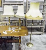 Brass reeded lamp standard on circular platform base and a pair of brass table lamps