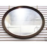 Old oval framed wall mirror with bevelled plate,