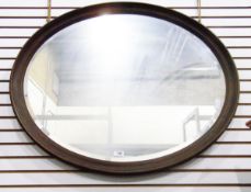 Old oval framed wall mirror with bevelled plate,