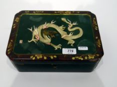 Japanese lacquered rectangular box with relief dragon to lid, 25.