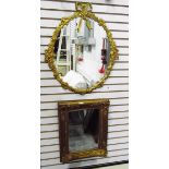 Modern gilt-coloured oval framed mirror with bow and floral decoration,