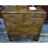 Reproduction walnut straight front chest of two short and three long graduated drawers,